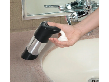 Person dispensing soap onto hand