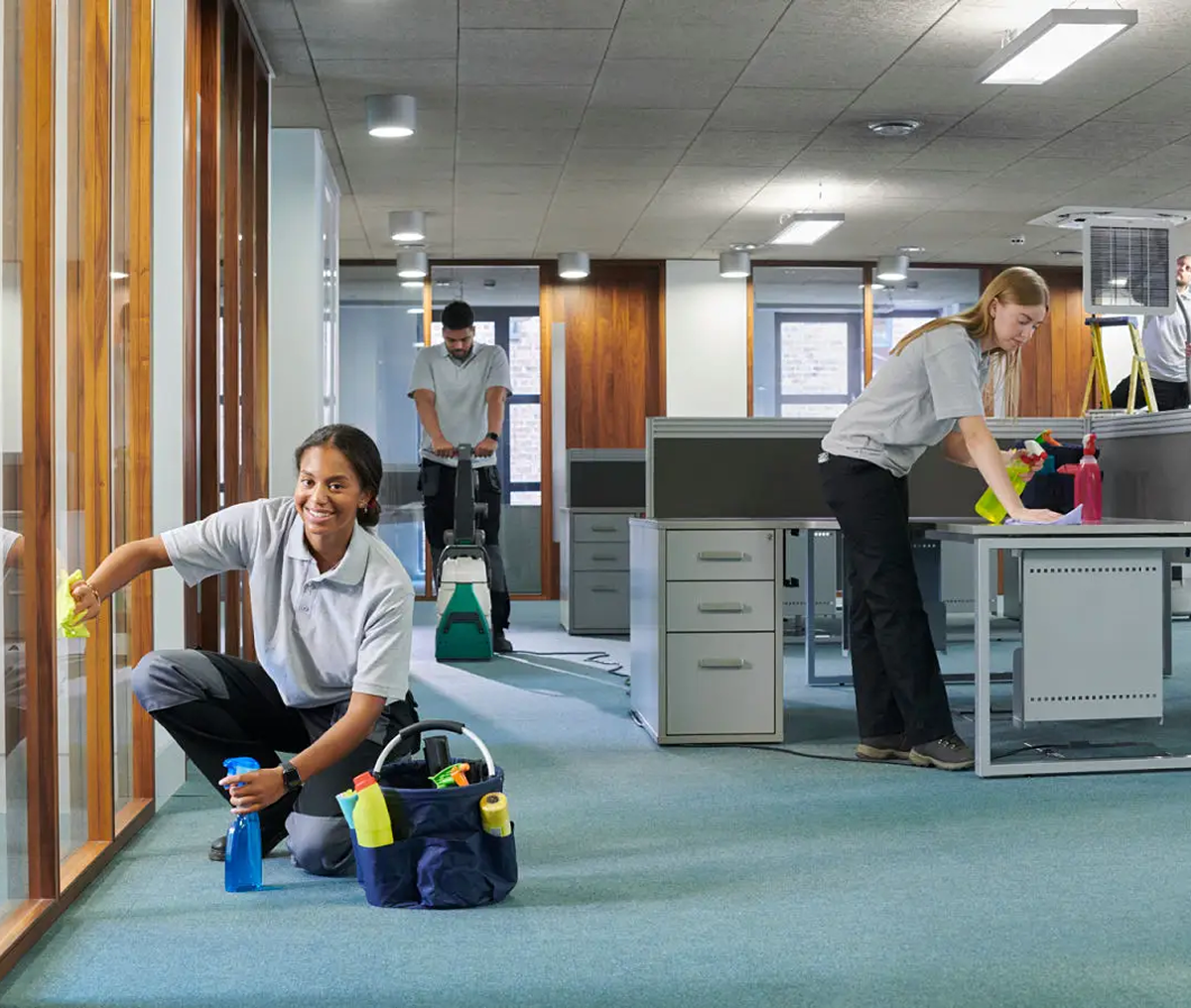 Office workers engaged in various tasks, including cleaning and organizing.